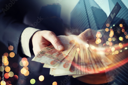 Businessman in suit holding money in his hands. Freedom, success man double exposure skyscraper