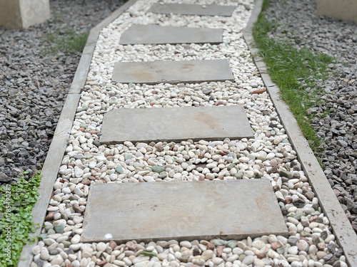 Landscaped Garden Walkway Featuring Concrete Steps and White Stone Accents