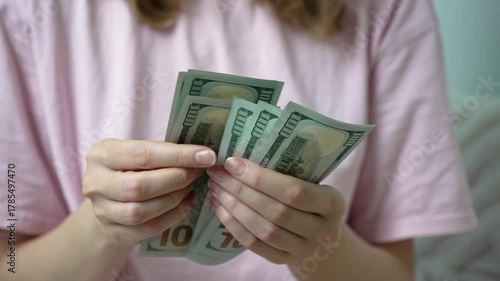 In a quiet room, a sick woman takes a deep breath as she counts bills. Each dollar represents a step toward healing and hope, as medical costs weigh heavily on her mind.