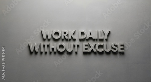 Motivational wall art with the phrase 'Work Daily Without Excuse' displayed in bold, three-dimensional letters on a plain gray wall to inspire productivity and determination