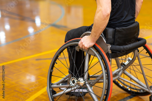 close image of the lower half of a man in a wheelchair on a basketball court