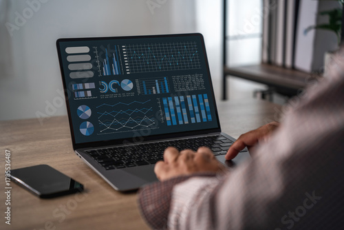 Intelligent analytics on screen with graphs and charts as business team reviews financial statement, discusses results, and aligns management decisions.