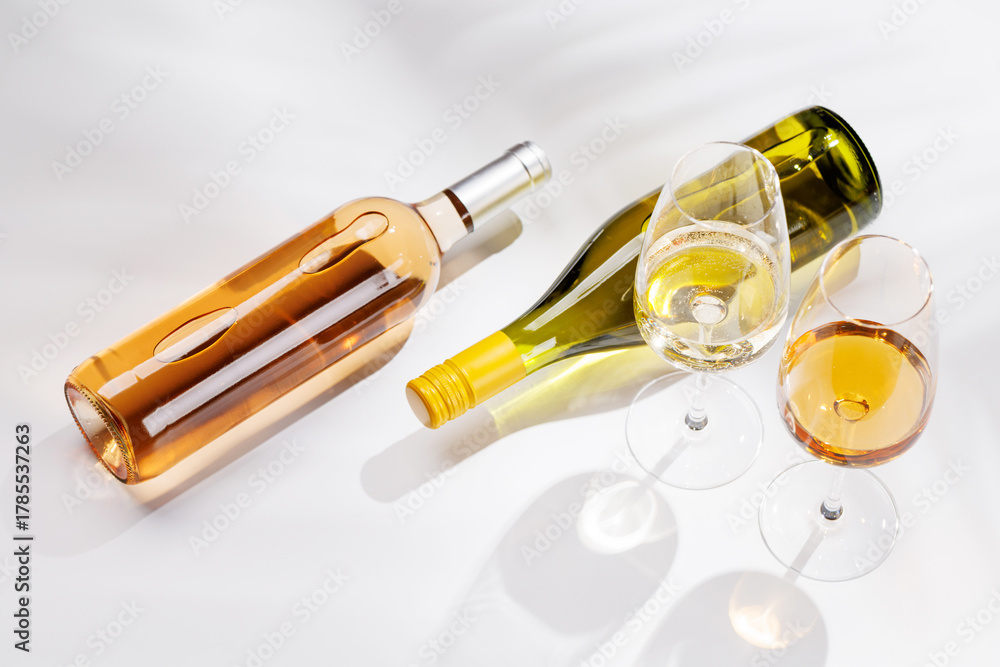 Fototapeta premium Different wine bottles and glasses on white background