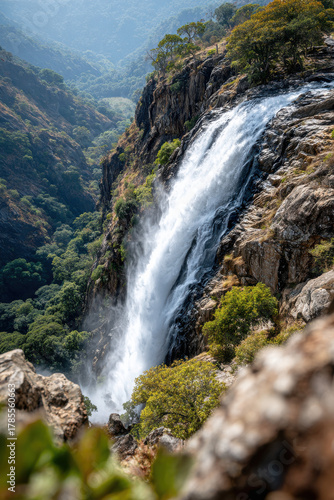 Majestic waterfall cascading down a rocky cliff in the jungle