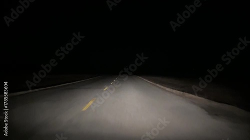 Windshield perspective of nighttime driving with lower visibility in rural Alberta Canada.