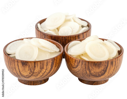 Three wooden bowls brimming with circular, pale-colored food items, isolated