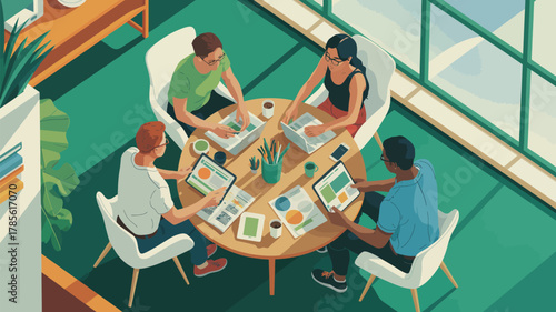 Aerial view of four people working at a round table with laptops and tablets in a green room near window