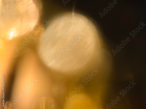 Bokeh background effect The atmosphere is very luxurious and precious. Glittering yellow gold diamonds fell. Contrasts beautifully with the black background.