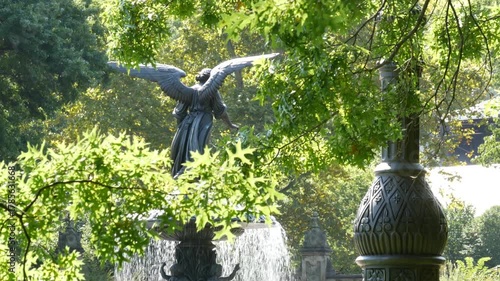 New York City Central Park Bethesda Fountain, angel statue by Bethesda Terrace on summer day, United States. Greenery and sculpture in morning. Autumn fall leaves and green trees in NYC Manhattan, USA