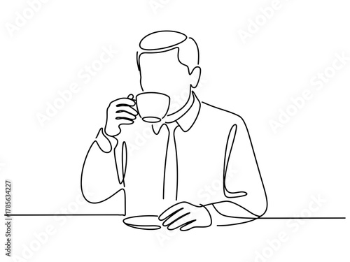A person in a white shirt and tie sips a cup of coffee while sitting at a table.