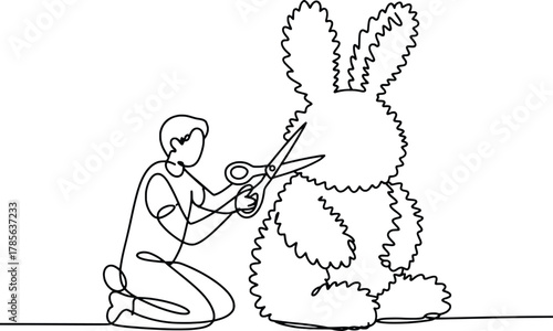 Artist carefully trims large fluffy easter bunny with scissors crafting joyful spring decoration