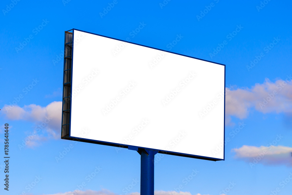 Obraz premium Advertising billboard along the road in the city on a sunny day. Background for design.