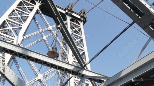 Williamsburg Bridge from Manhattan to Brooklyn, New York City, USA. Architecture of United States, tourist landmark. Metallic cable-stayed bridge. Cables and sky from pedestrian path. Low angle.