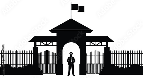 Security guard stands at entrance gate with flag flying high