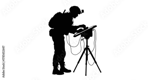 Soldier operates tactical equipment, focused on mission success