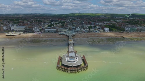Drone aerial footage of Worthing Pier and the beach of the city. Worthing is a seaside town and borough in West Sussex, England.