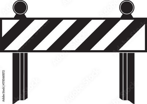 Black and white striped construction barrier with flashing lights indicating road closure or work zone safety measures