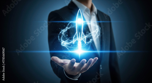 Businessman suit hand digital rocket hologram innovation technology startup futuristic glowing launch success ambition professional concept blue light energy creative leadership
