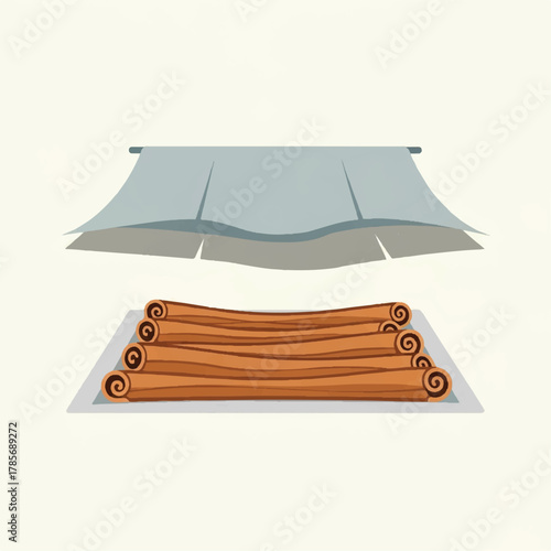 Cinnamon sticks on a tray under a light blue tarp