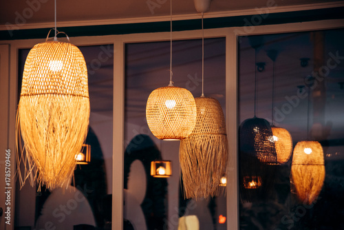 Wallpaper Mural A row of wooden lamps with a warm glow. The lamps are hanging from the ceiling and are lit up. Torontodigital.ca