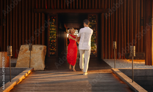 Couple arriving for premium dining at luxury resort restaurant