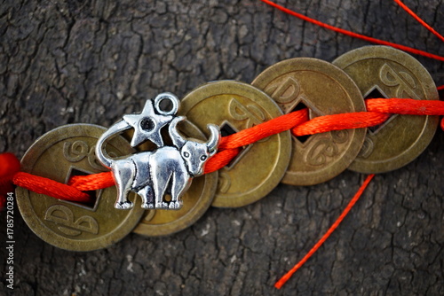 A Chinese feng Shui coin and a metal bull figurine.