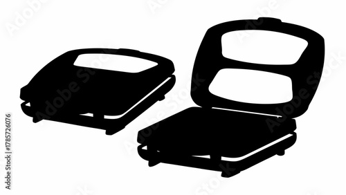 Two waffle makers depicted in silhouette one closed and one open showing the cooking surface detail