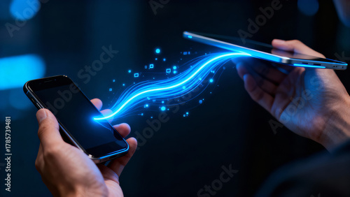 Technology meets connection in a digital transfer scene between a smartphone and tablet