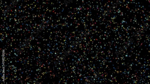 Rainbow microparticles, moving slowly against a black background. Colorful shiny particles. Multi-colored dots drifting in a dark space.