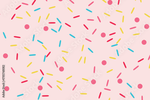 A pink background with scattered colorful sprinkles, including red, yellow, and blue dashes, and pink dots, creating a festive and sweet pattern.