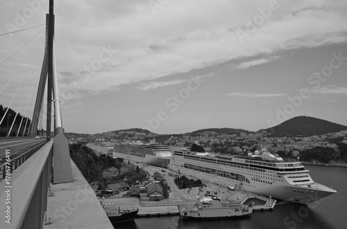 Italian family cruiseship cruise ship liner Lirica, Armonia or Sinfonia in port of Dubrovnik, Croatia during Summer Mediterranean cruising with harbor infrastructure marine traffic
