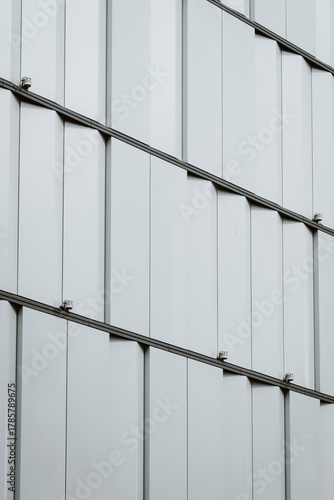 Black and white modern architecture facade pattern showing geometric structure and detailed texture with minimal symmetry captured from an oblique angle
