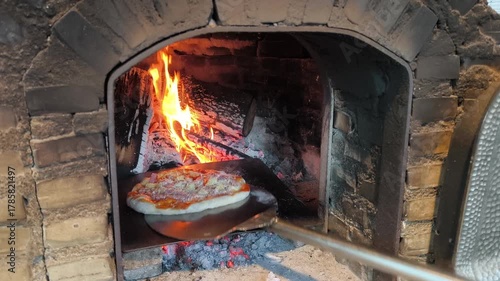 The warmth of the fire fills the oven, waiting for the first pizza to bake.