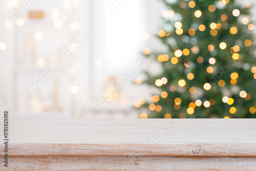 Bleached wood table top for your product presentation on deeply blurred Christmas fir tree lights interior background