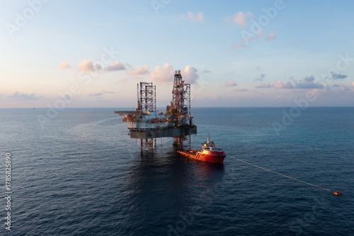 Offshore jack up rig in aerial view in the middle of the ocean taken by a drone