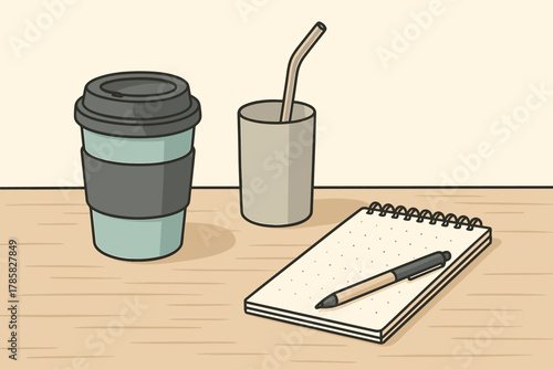Reusable coffee cup with dark lid and sleeve, metal straw in tumbler, and spiral-bound notebook with a pen on wooden table.