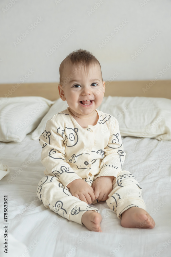 Fototapeta premium Portrait Joyful baby in bear print pajamas