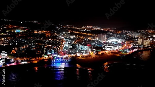 Wallpaper Mural Aerial view of the night city from the beach with a laser show in the background Torontodigital.ca