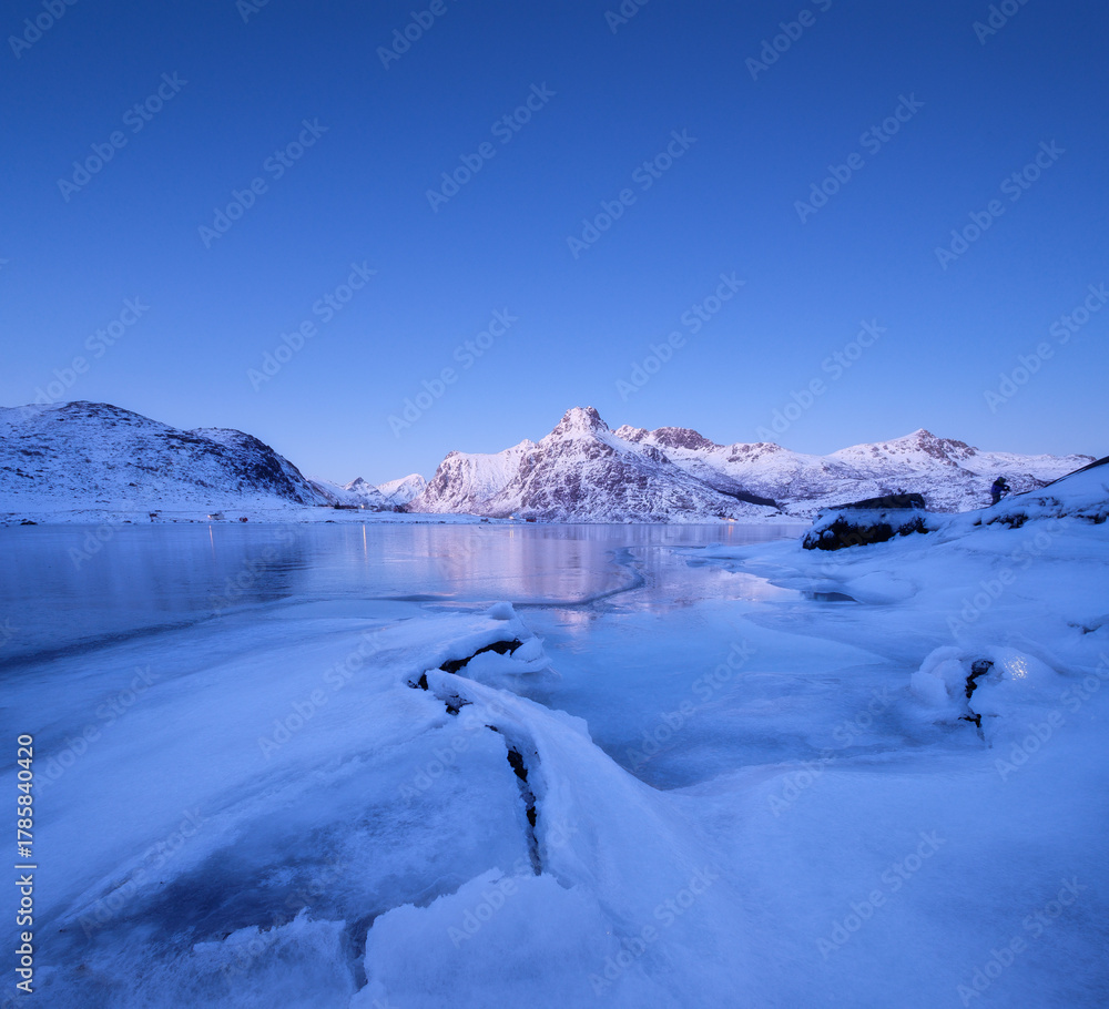 Obraz premium Norway. Nature in the fjords during winter. High mountains, ice and reflections. Scandinavia. Vacation and travel in the winter north. Background, wallpaper, postcards.