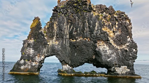 Wallpaper Mural Close drone shot of Hvítserkur, Iceland. Basalt rock arch in the sea under bright Arctic light. Torontodigital.ca