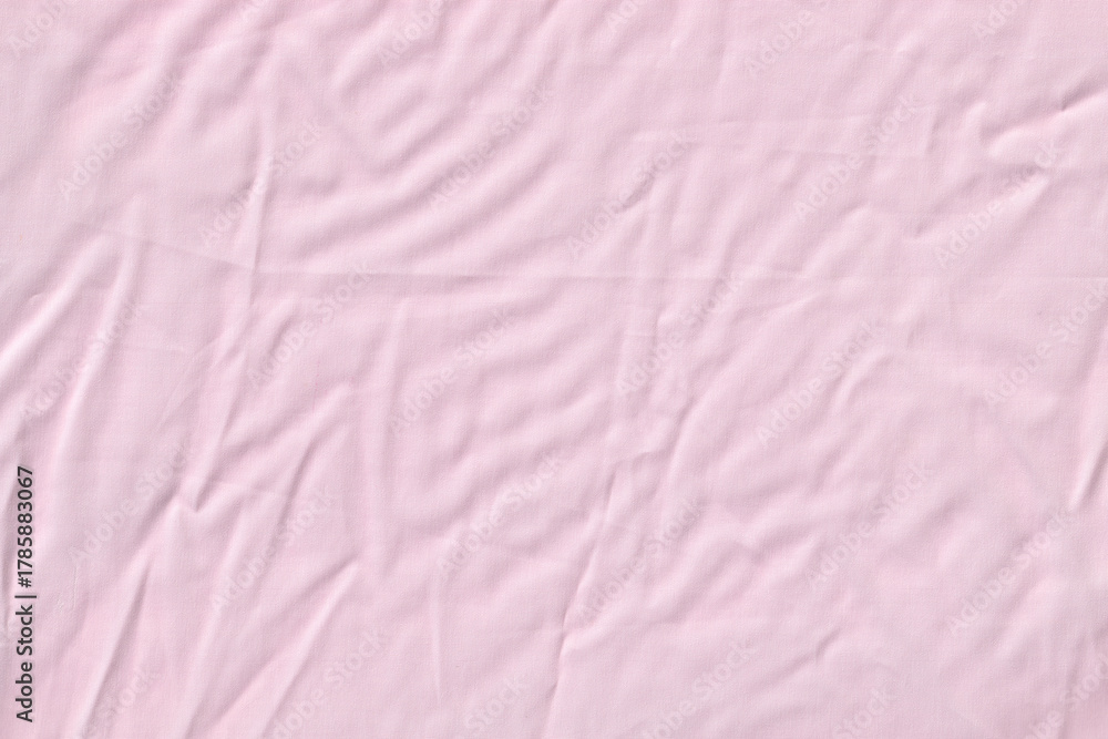 Fototapeta premium Light Pink Wrinkled Fabric or Crumpled Bed Sheet Texture Background.
