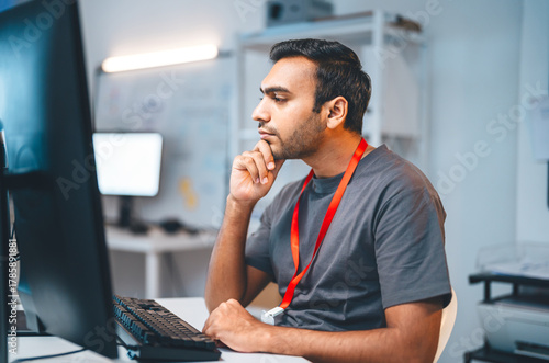 Indian programmer coding typing keyboard in modern office software developer programming IT technology career