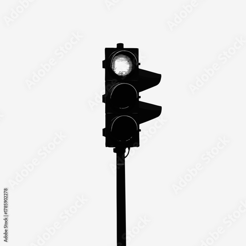 A black and white traffic light icon. Minimalist silhouette of a stoplight with the go signal on. Urban road safety and transportation graphic