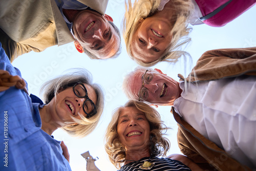 Quadro su tela Senior friends smiling looking down into camera