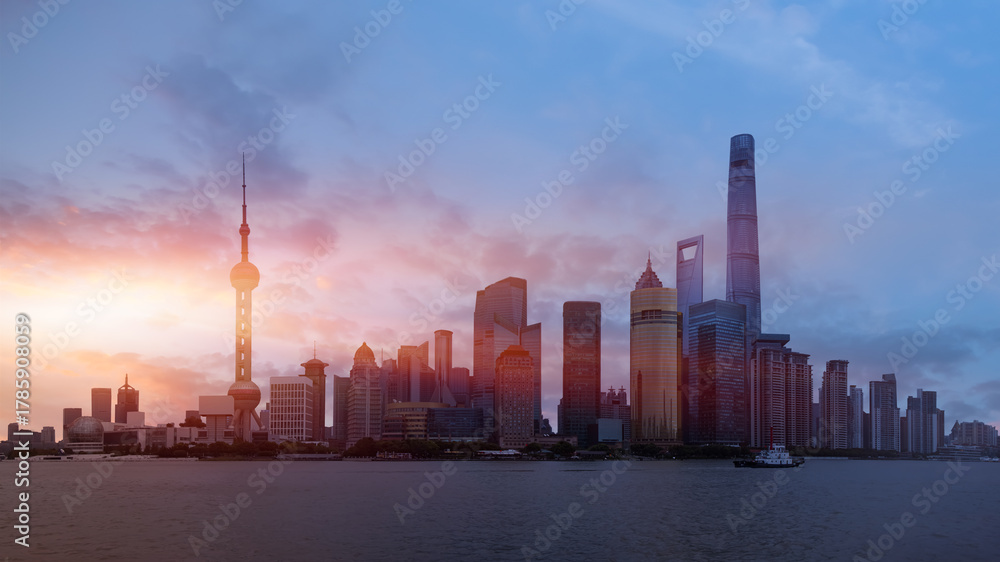 Fototapeta premium Shanghai colorful skyline with motion speed light of passing ferry in the foreground at sunset - Shanghai, China