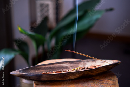 Close-up of incense burning inside the house.