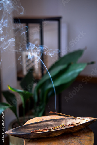 Close-up of incense burning inside the house.