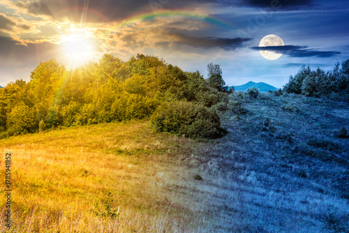mountain landscape with foliage forest on autumn equinox. day and night time change concept. beautiful beech woodland on rolling hills in highland with sun and moon. duality and transition template