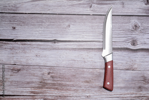 Kitchen knife on a wooden background. Knife with a blade of a wooden handle. Set of different knives