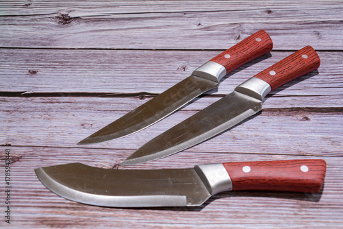 Kitchen knife on a wooden background. Knife with a blade of a wooden handle. Set of different knives